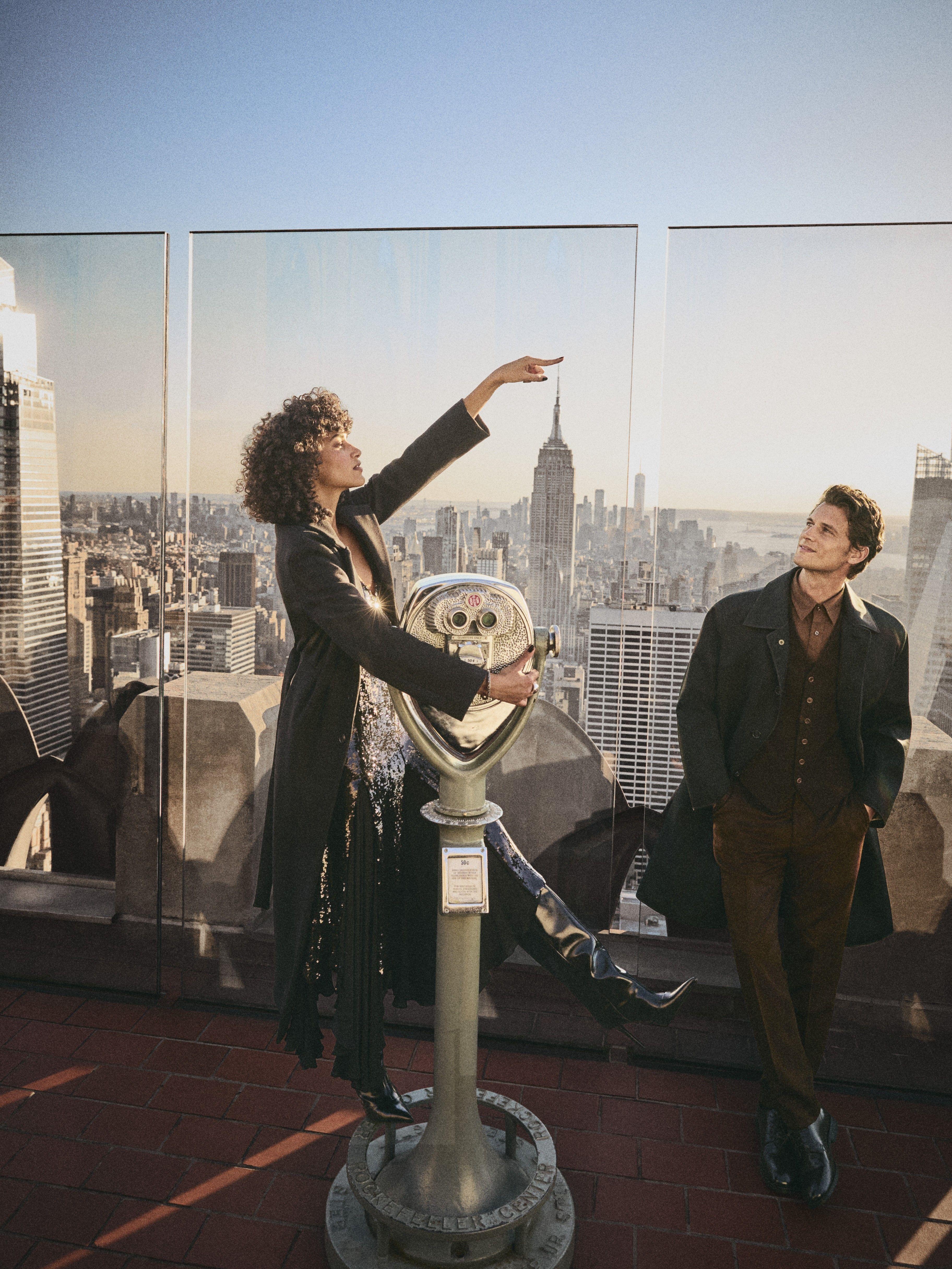 a man and woman at top of the rock